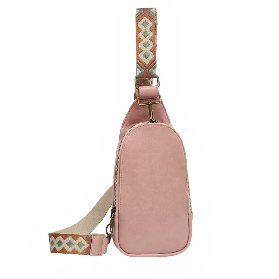 "Chic pink vegan leather crossbody bag featuring an adjustable strap and minimalist design."