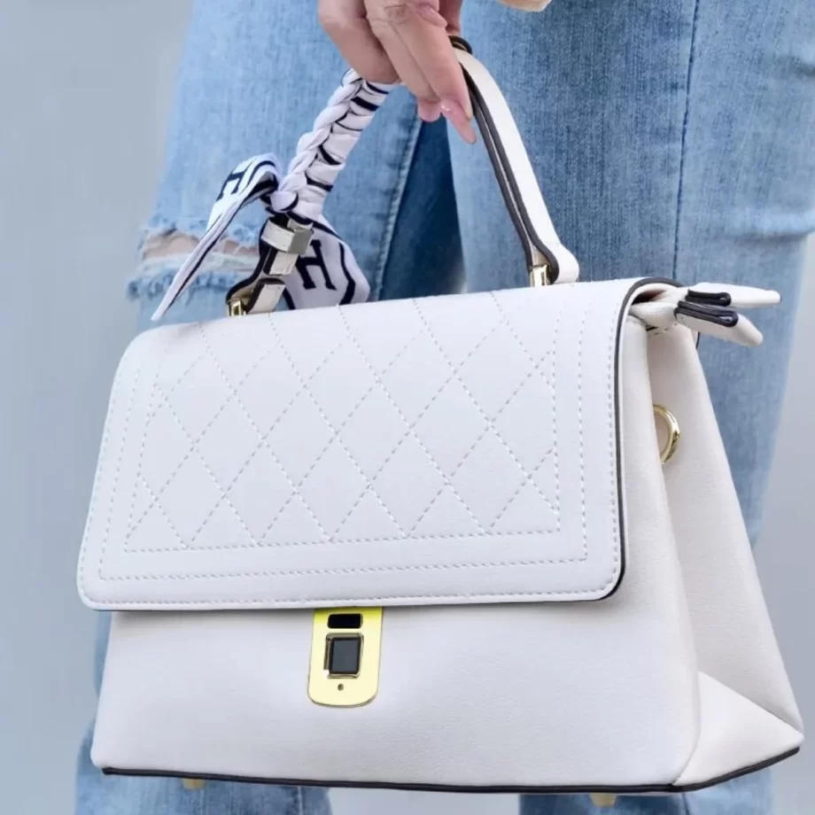 Pearl Elegance Handle Tote: A stylish white handbag featuring a sleek design, gold-toned clasp, and a braided handle, embodying elegance and refined style.